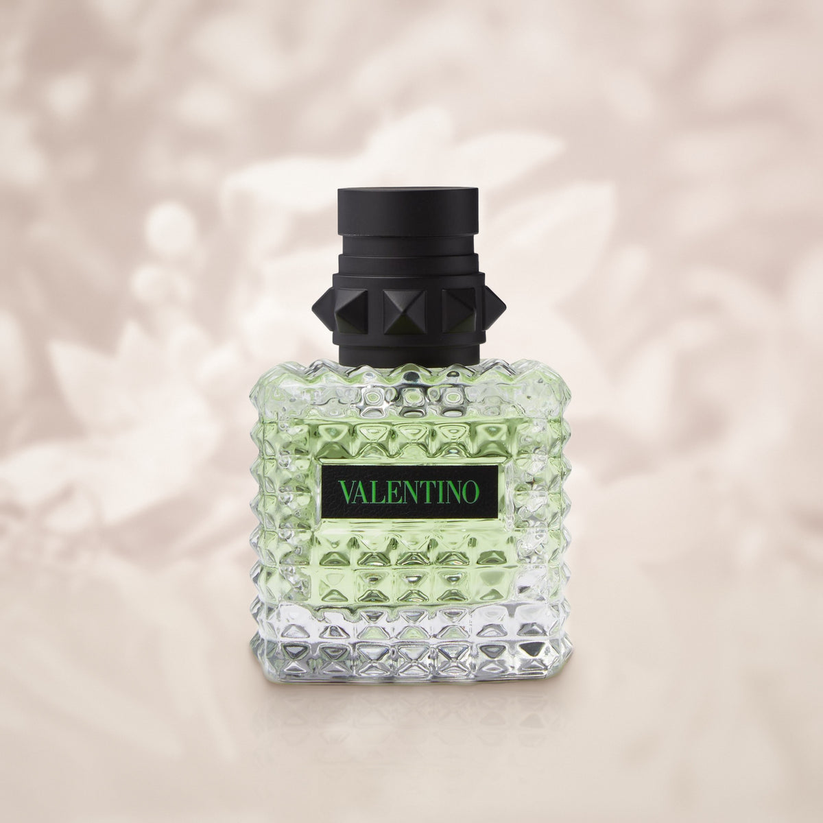 Valentino Born in Roma Green Stravaganza 30ml bottle on a soft ivory jasmine blossom background