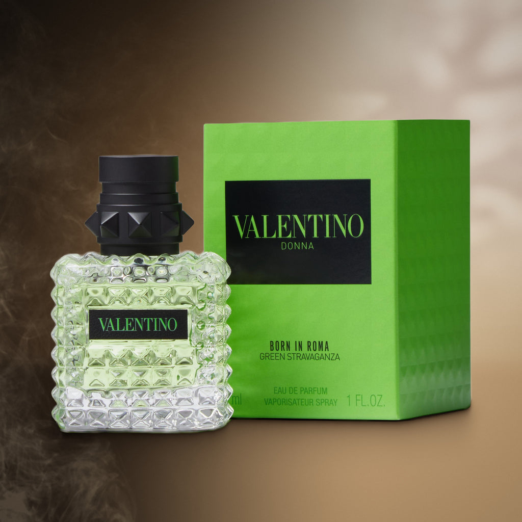 Valentino Born in Roma Green Stravaganza 30ml bottle and box on a smoky tea to creamy vanilla fragrance notes background