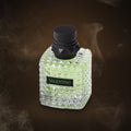 Valentino Born in Roma Green Stravaganza 30ml bottle on a moody smoky Lapsang Souchong tea background